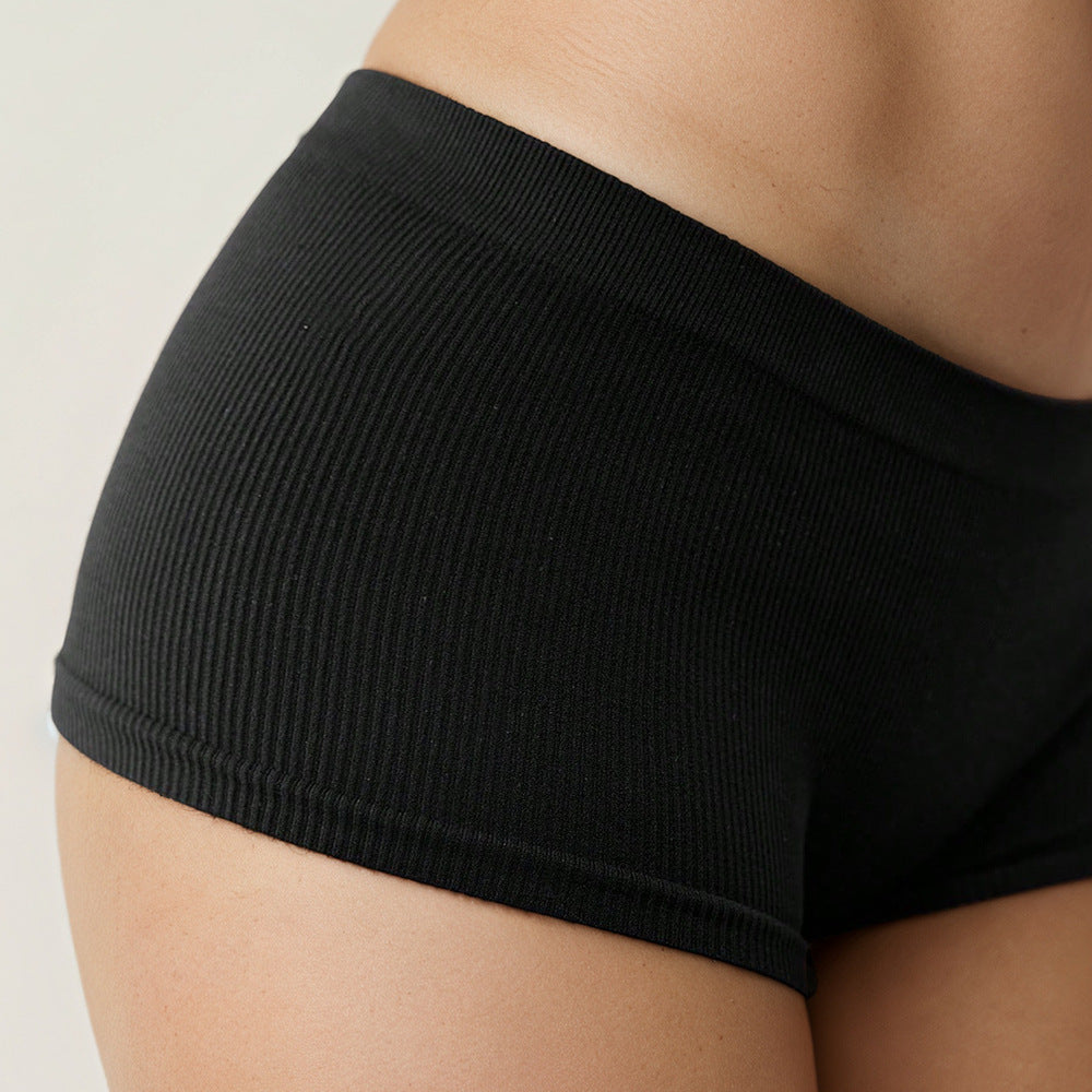 Black Shelliy Brief Side Hip Close-up On Beige Backdrop — On-body