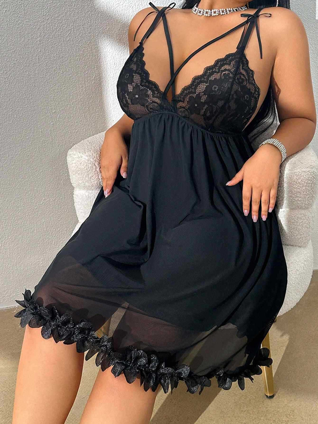 Black mesh babydoll nightdress on model, seated on a cream upholstered chair — Shelliy Coquette
